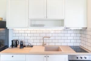 A kitchen or kitchenette at Two Olive Trees - Deluxe Apartments