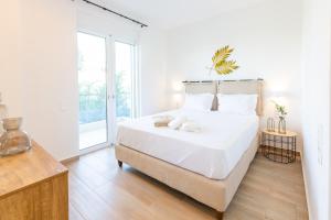 A bed or beds in a room at Two Olive Trees - Deluxe Apartments