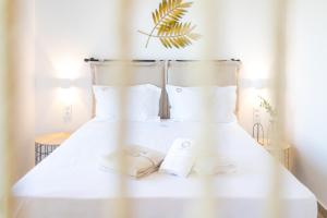 A bed or beds in a room at Two Olive Trees - Deluxe Apartments