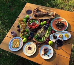 a wooden table with plates of food on it at Baresha Agroturizem in Gradiskije