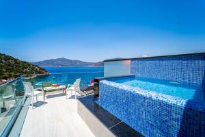 a swimming pool on the balcony of a house at GREENBEACH HOTEL in Kalkan