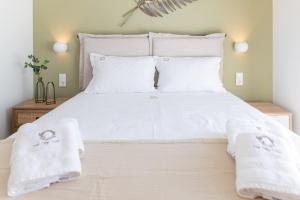 A bed or beds in a room at Two Olive Trees - Deluxe Apartments