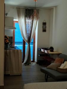 a living room with a curtain and a table at Hercules House - Il riposo degli Eroi in Ercolano