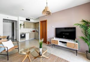 a living room with a large flat screen tv at Water Front Blue Lguna Garden Apartment 2bd in Herzliya B