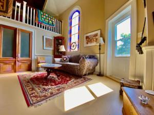 a living room with a couch and a table at Unique Stay! Converted Church In Idyllic Location in St. John's