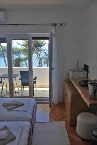 a living room with a view of a patio with a table at Covahouse in Jelsa