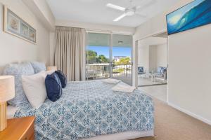 a bedroom with a bed and a view of the ocean at Drift Apartments - Tweed Coast Holidays ® in Kingscliff