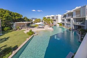 a swimming pool in the middle of a building at Drift Apartments - Tweed Coast Holidays ® in Kingscliff
