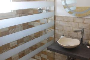 a bathroom with a sink and a mirror at Il Galletto bb in Patù +21 photos