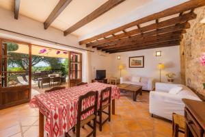 a living room with a table and a couch at Es Rafalet - Sa Buhardilla Petita in Manacor