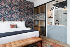 a bedroom with a bed with a floral wallpaper at ARRIVE Memphis in Memphis