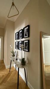 a table in a room with pictures on the wall at GMarconi Suites in Campobasso