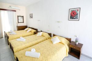A bed or beds in a room at Gardenia Hotel