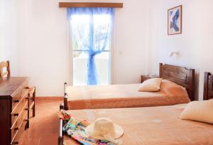 A bed or beds in a room at Gardenia Hotel