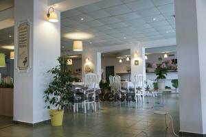 a dining room with white chairs and a table at Sirena Hotel- ALL INCLUSIVE in Sunny Beach