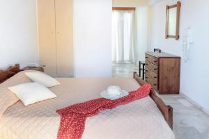 A bed or beds in a room at Gardenia Hotel