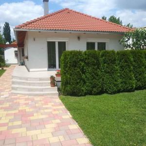 a house with a brick walkway in front of a yard at Holiday home in Keszthely/Balaton 39648 in Keszthely
