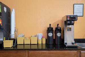 a counter with a coffee maker and cups on it at Red Roof Inn Mobile - Midtown in Mobile
