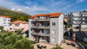 an apartment building with an orange roof in a city at Luxury apartments Budimir in Podstrana