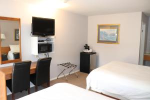 A bed or beds in a room at Clearwater Country Inn