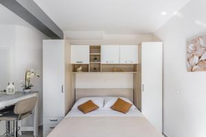 a small bedroom with a bed and a desk at Luxury apartments Budimir in Podstrana