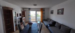 a living room with a couch and a table at Apartments and Rooms Stipe in Podstrana