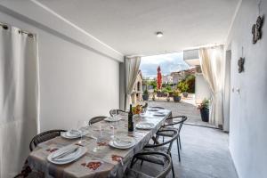 a dining room with a long table and chairs at Luxury apartments Budimir in Podstrana