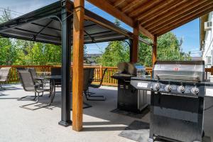 a patio with a grill and a table and chairs at Cedar Motel in Radium Hot Springs