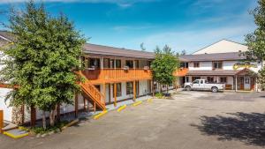 a building with a car parked in a parking lot at Cedar Motel in Radium Hot Springs