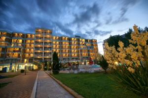 a large building with lights on at dusk at Sirena Hotel- ALL INCLUSIVE in Sunny Beach