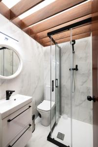 a bathroom with a shower and a toilet and a sink at Bento Box Villa Family Hub Fitness & Spa in Vilamoura