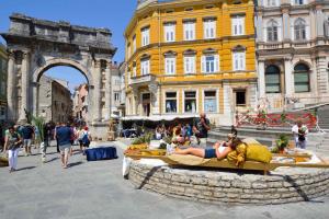 a woman laying on a fountain in a city at Apartment in Pula - Istrien 36865 in Veli Vrh