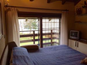 a bedroom with a bed and a large window at Holiday home in Madonna Del Sasso 22866 in Madonna del Sasso