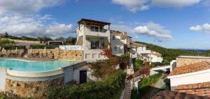 a villa with a swimming pool on a hill at Holiday home in Baja Sardinia 30355 in Baja Sardinia