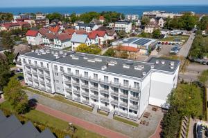 an aerial view of a white building in a city at Planeta in Ustronie Morskie