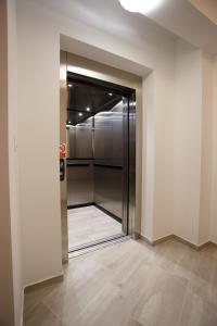 a walk in closet with a glass door at Planeta in Ustronie Morskie