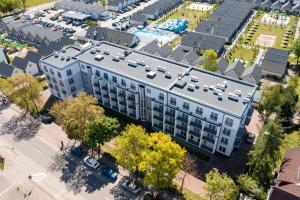 an overhead view of a large white building with a parking lot at Planeta in Ustronie Morskie