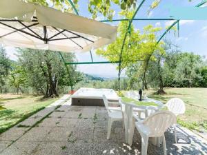 a patio with a table and chairs and an umbrella at Apartment in Bagno a Ripoli/Toskana 23871 in Villamagna