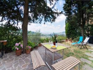 a patio with a table and two chairs and a table and benches at Apartment in Bagno a Ripoli/Toskana 23871 in Villamagna