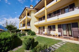 an apartment building with a lawn in front of it at Apartments in Malcesine/Gardasee 22016 in Assenza di Brenzone