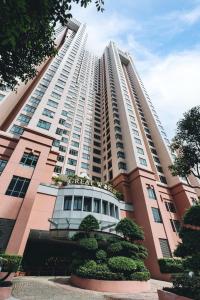 a large white building with trees in front of it at Great World Serviced Apartments in Singapore