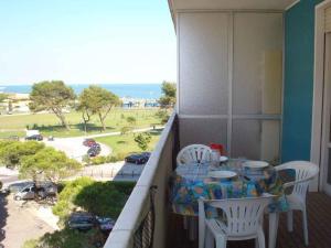 a balcony with a table and chairs and a view at Apartments Porto Santa Margherita 25671 in Porto Santa Margherita di Caorle
