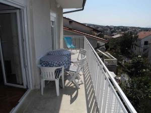 a balcony with a table and a chair on a balcony at Apartment in Selce 5818 in Selce