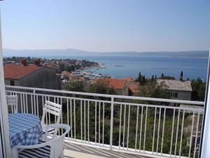 a balcony with two chairs and a view of the water at Apartment in Selce 5818 in Selce