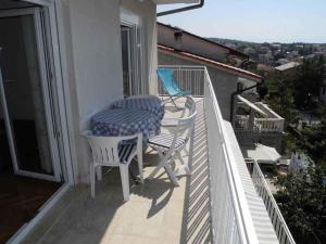 a table and chairs on a balcony with a view at Apartment in Selce 5818 in Selce