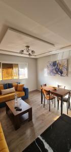 a living room with a couch and a table at Bonne étoile Imsouane in Imsouane
