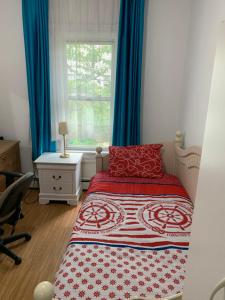 a bedroom with a bed and a window with blue curtains at Classical American House 4 in Brooklyn