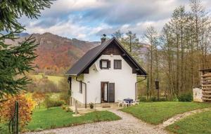 a small white house with a black roof at Holiday home in Turke - Gorski Kotar 35160 in Turke
