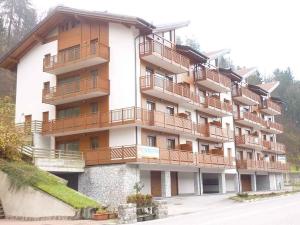 a large building with balconies on the side of it at Apartments in Comano 24163 in Comano Terme