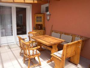 a wooden table and chairs in a room at Holiday home in Balatonszentgyörgy 20188 in Balatonszentgyörgy